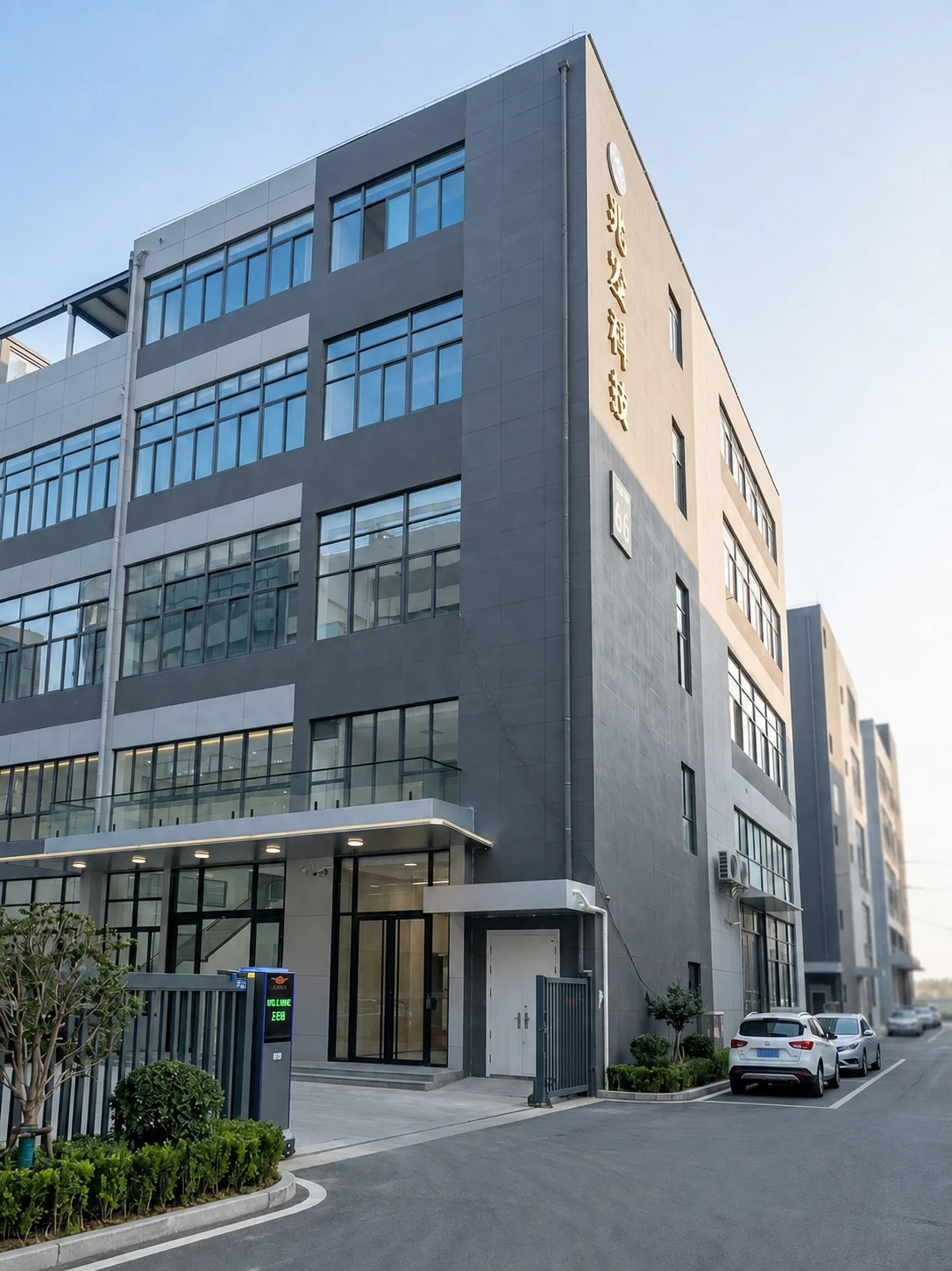 Exterior of the factory, with glass windows and landscaped entrance